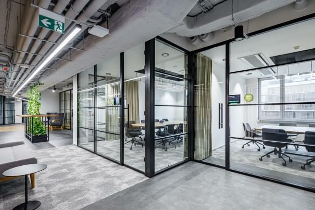 spacious corridor with glass walls and plant element