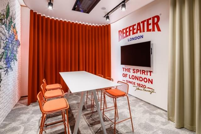 meeting room with bar table, themed graffiti and Beefeater sign