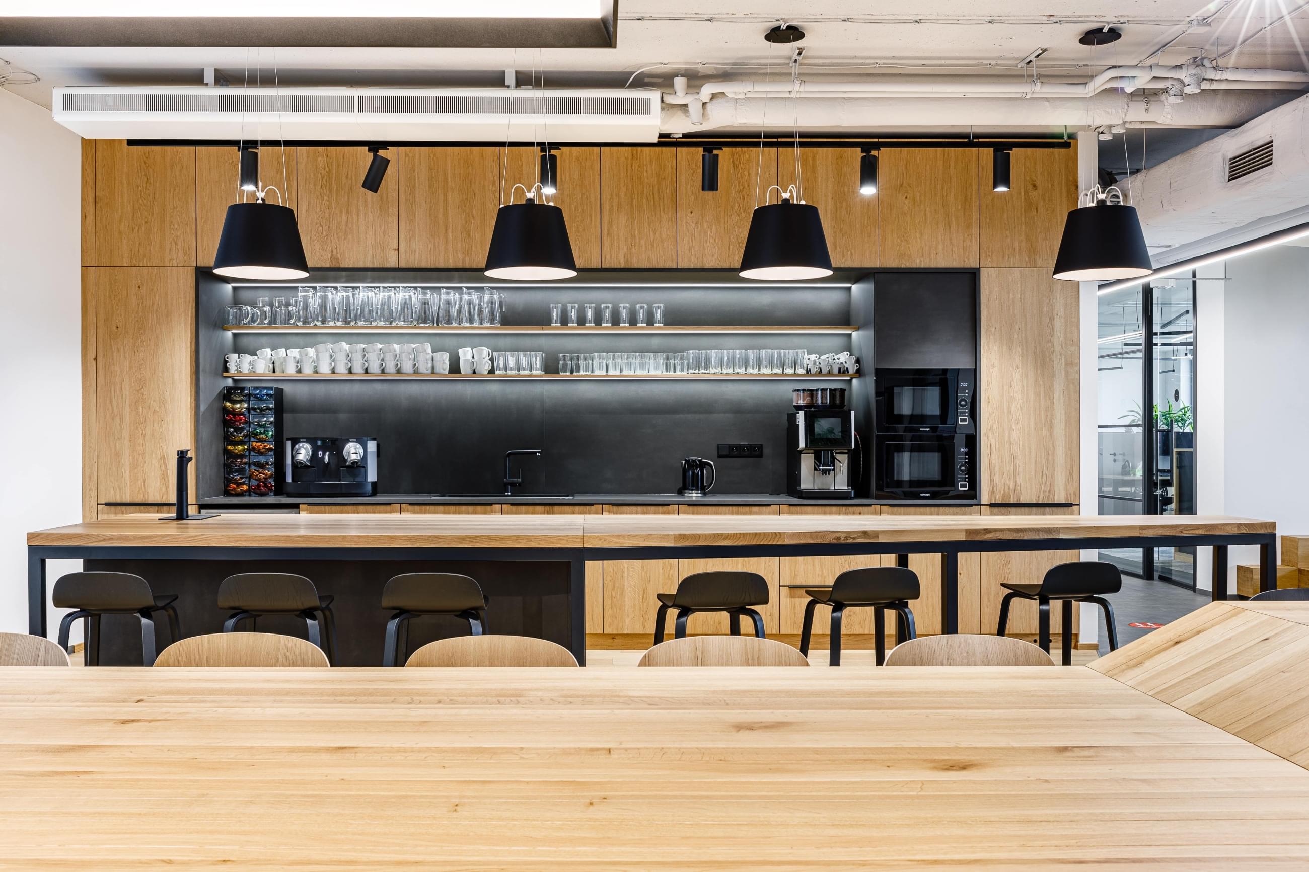 Solid wood kitchen with black details in a minimalist interior 