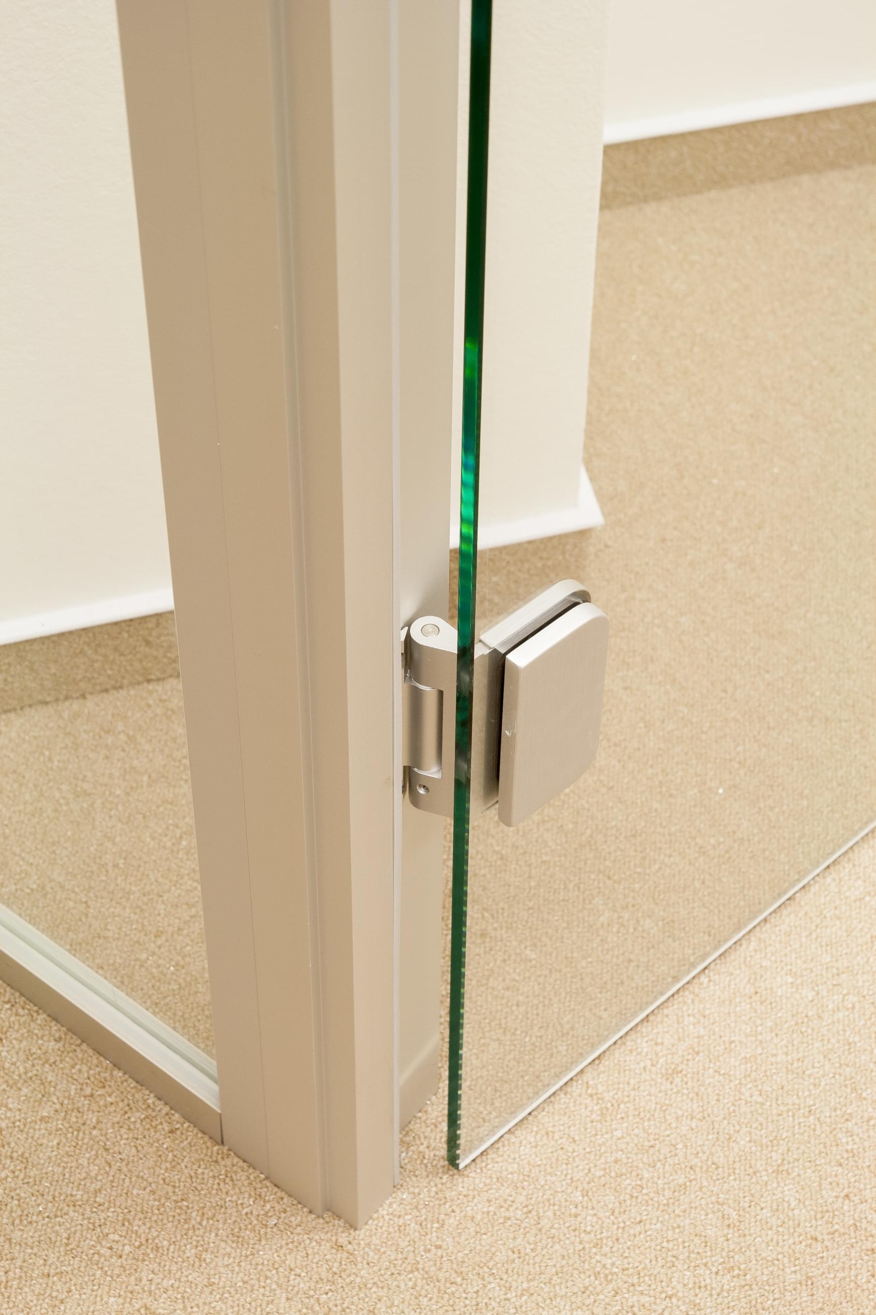 A detailed look at the elegant combination of glass doors and chrome hinges.