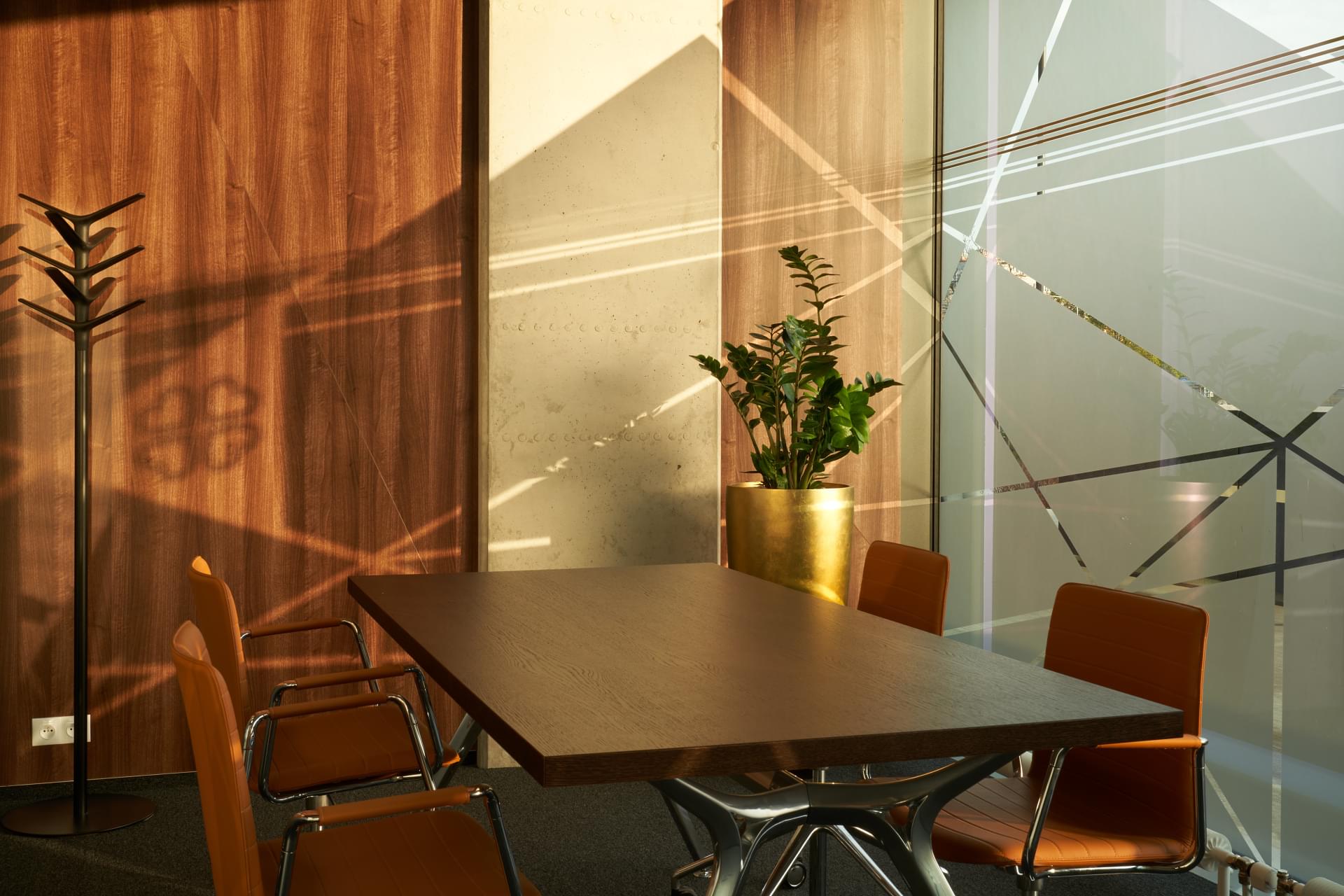 Meeting room in a minimalist design with a golden flower pot