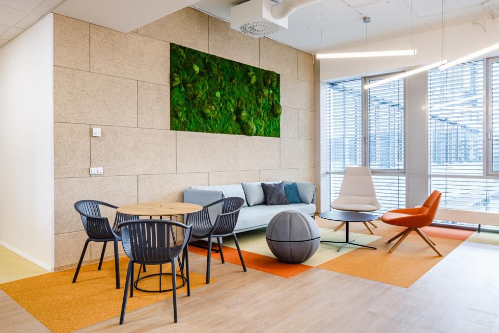 Natural daylight coming into the office through large windows.
