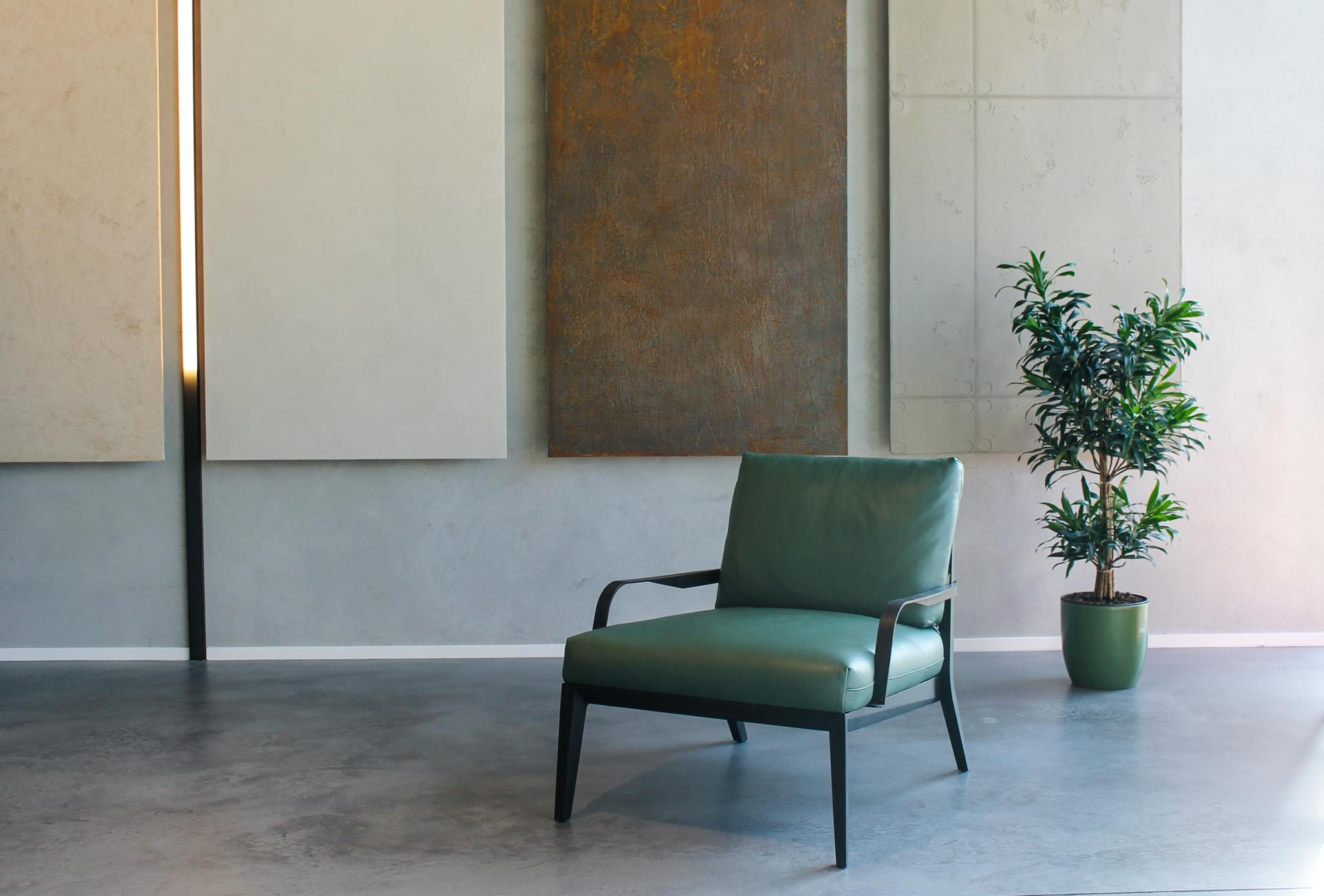 Designer leatherette armchair in green in 3deco showroom