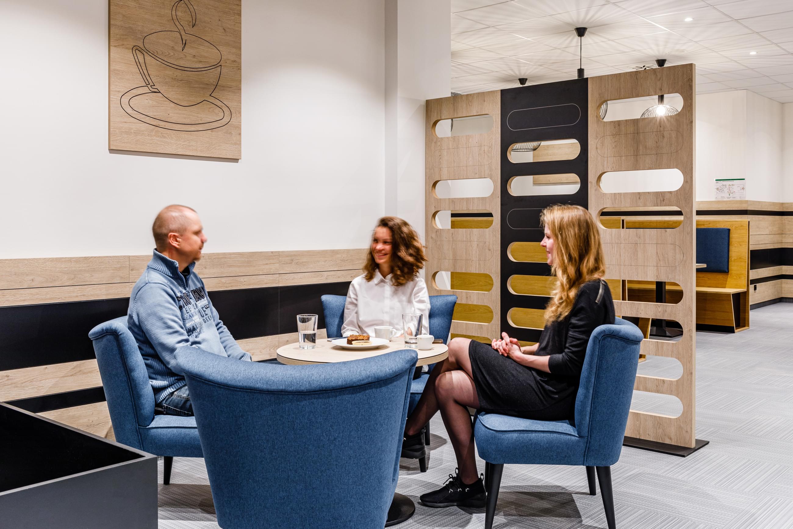 The tables with blue chairs are suitable for enjoying a cup of coffee at BHS Oregon House