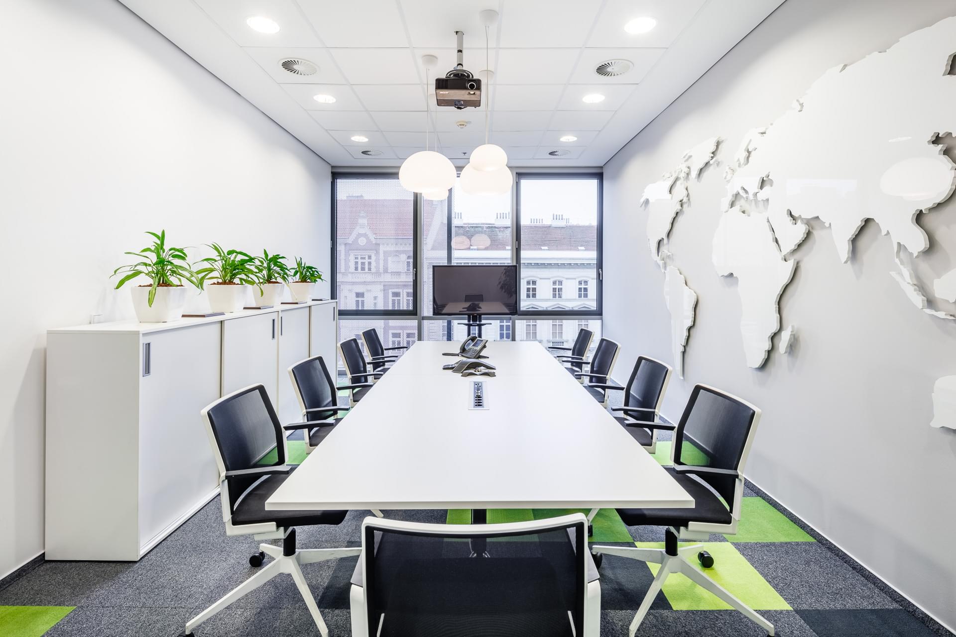 Conference space with a shining world map on the wall at CBRE