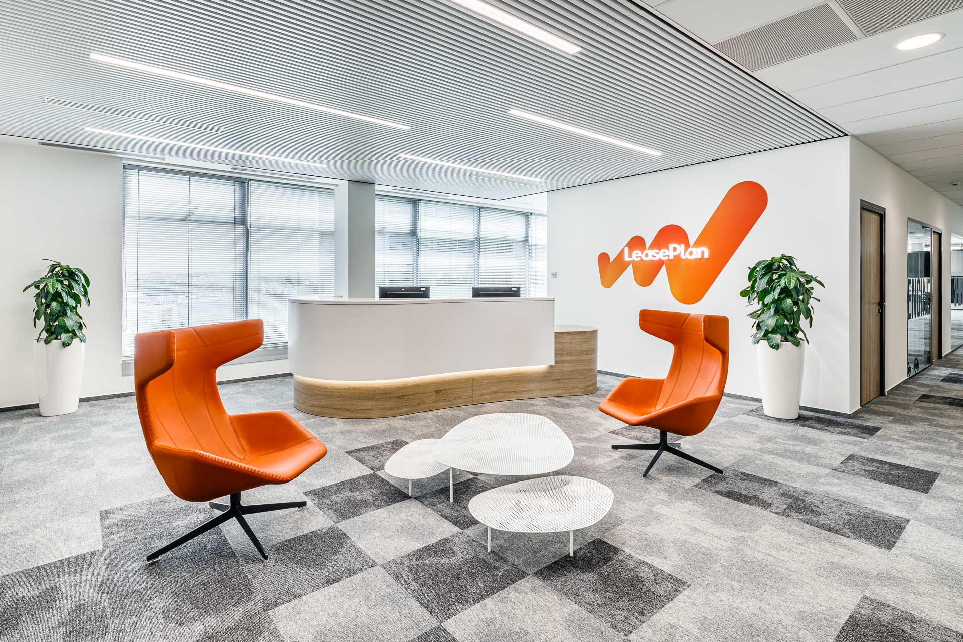 Backlit reception desk with LeasePlan logo on the wall