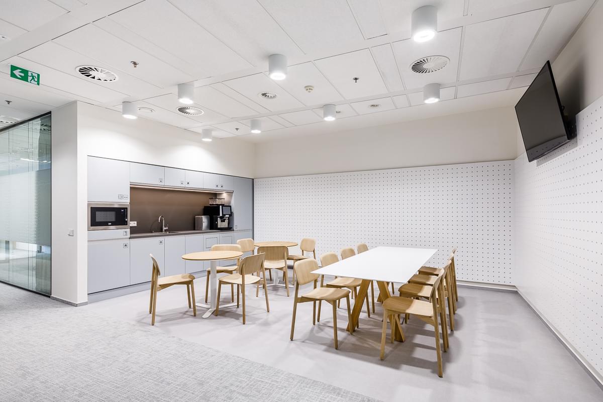 Corporate kitchen with wooden furniture and acoustic elements