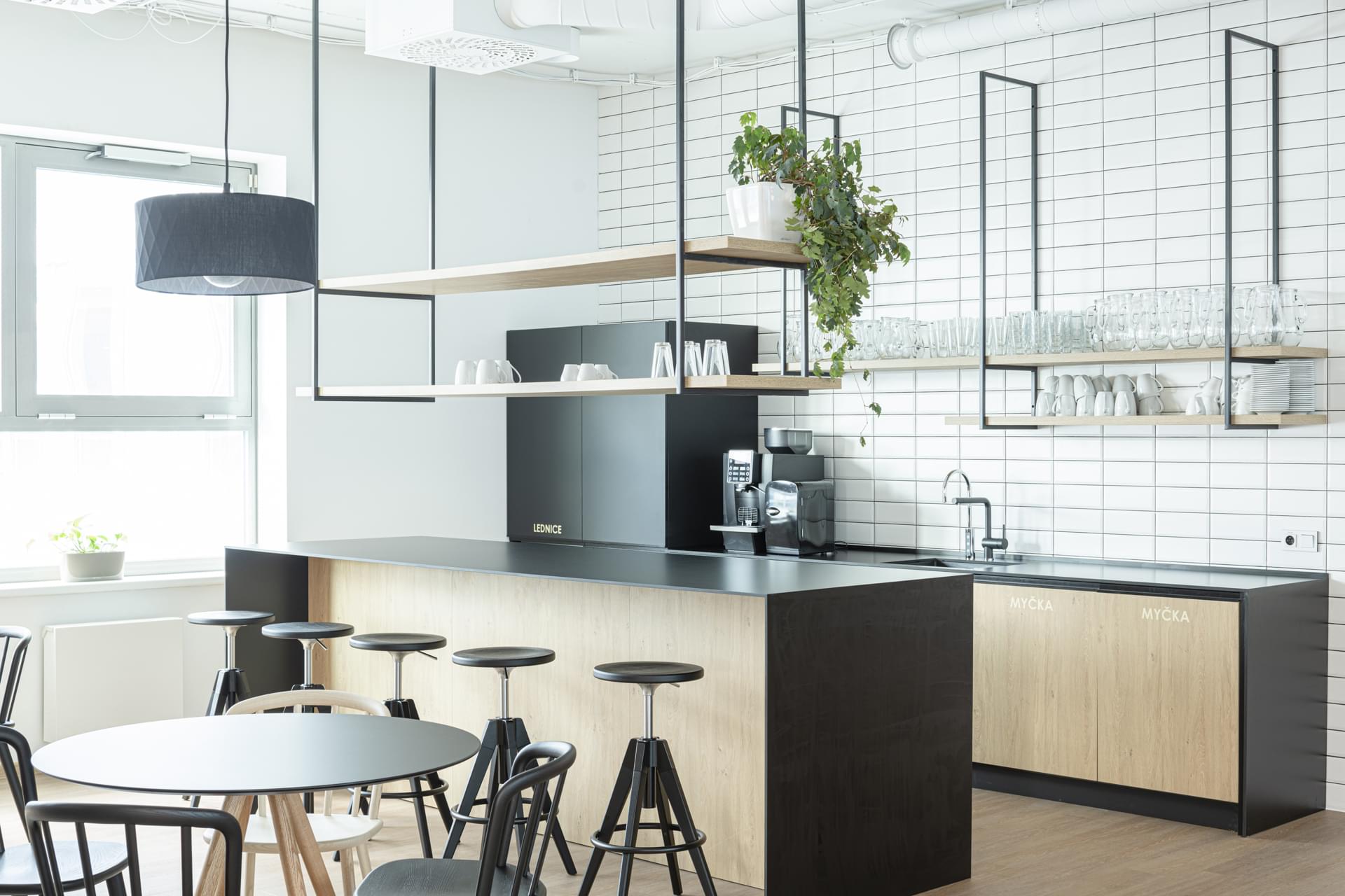 Modern kitchen area with bar seating and a kitchen island in the T-Mobile company