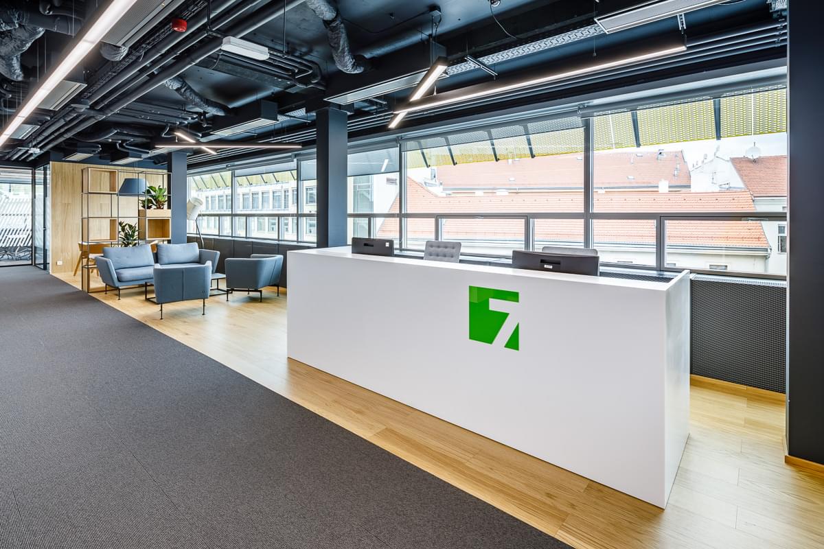 Recepční pult s logem společnosti Sev.en Energy. 