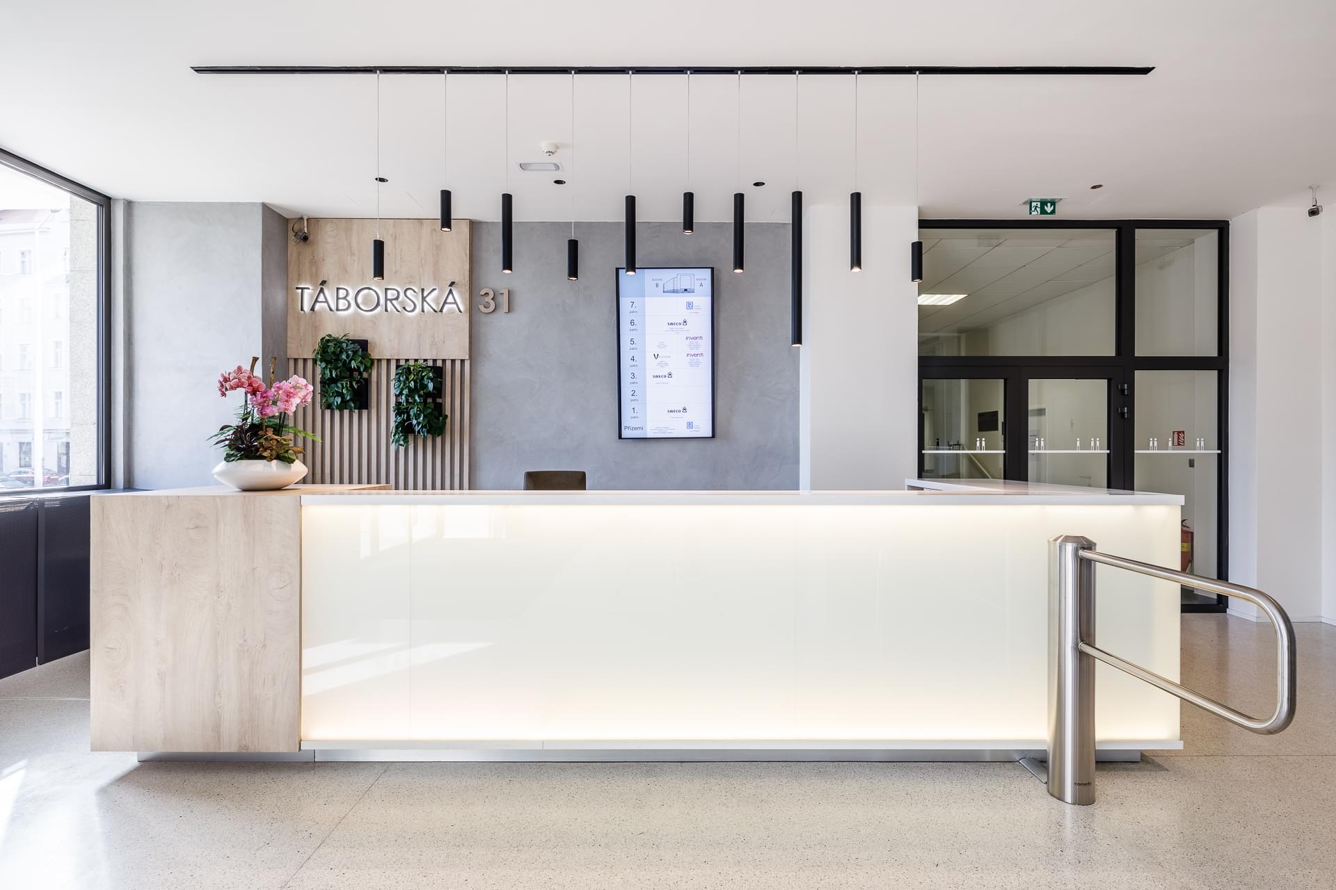 Above the reception there is a backlit sign Táborská 31