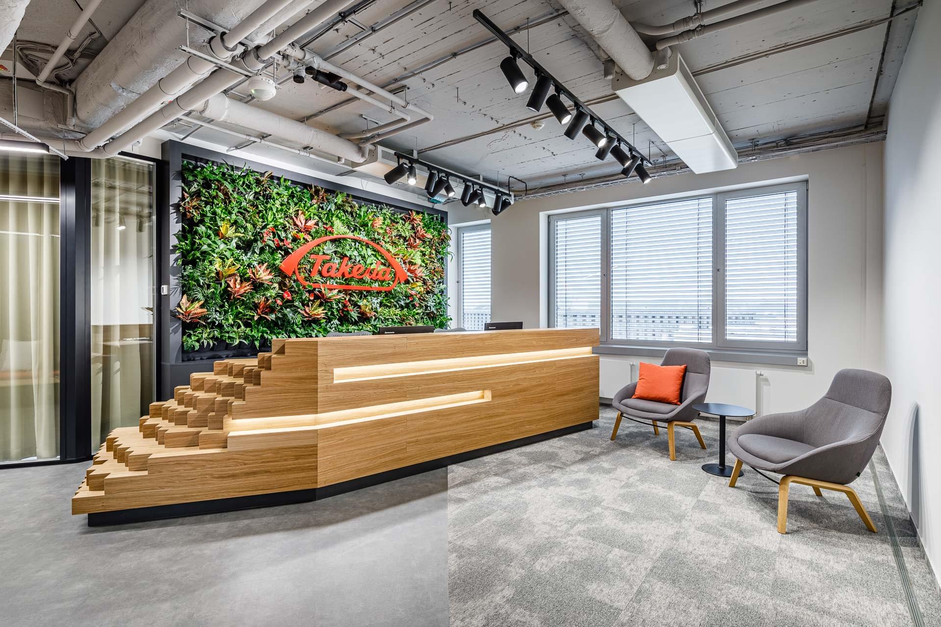Wooden reception desk with biophilic elements in Takeda Pharmaceuticals offices