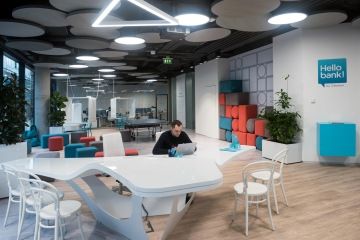 Acoustic panels installed on the ceiling and walls provide acoustic comfort and lighting optically separates the zones by function.