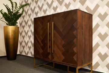 Dark wooden cabinet with the same motif as the wallpaper