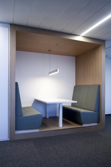 Atypical furniture set in a wooden frame that gave the impression alcove equipped with comfortable sofas and soft lighting.