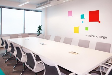 Meeting room is in shades of gray with colorful, decorative elements.