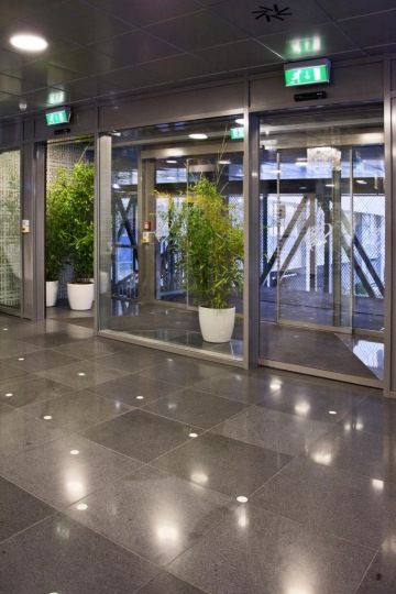 Glazed entrance with live plants to the Allianz reception in the Diamond Point building.