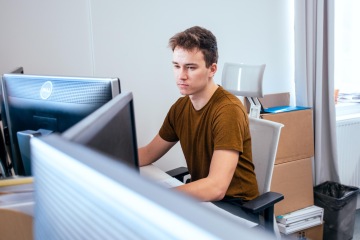 Young colleague sitting at the computer