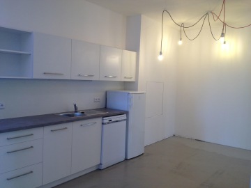 IT společnost manGoweb má ve svých kancelářích novou bílou kuchyni a osvětlení pomocí moderních vysacích barevných, červených a černých kabelů s led žárovkami.