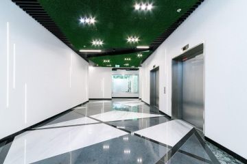 A corridor from the elevator lobby is ending by the bubble wall.