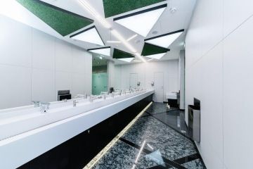 Toilets with atypical triangular lighting and LED strips.