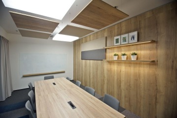 Meeting rooms with labeled glas partitions.