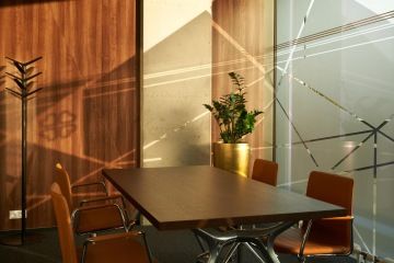 Meeting room in a minimalist design with a golden flower pot