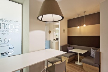 Seating for a short meeting was made in dark tones matching acoustic panels on the walls.