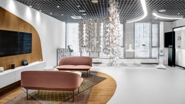 Soft seating seats supplemented with footstools in the showroom for Tatra banka