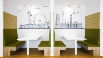 Coworking environment with comfortable armchairs and wallpapers at Regus