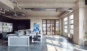 Openspace s odhaleným betonovým stropem a obrazem na stěně