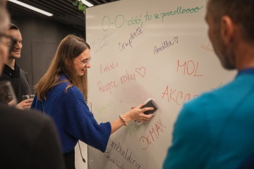 Colleagues write on the achievement board