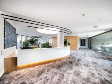 Vstupní prostor s podsvětleným recepčním pultem a designovým kobercem