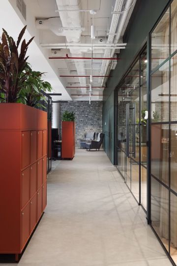 Corridor with modern cabinets, plants and seating