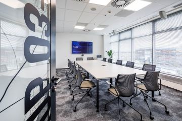 Zasedací místnost s konferenčním stolem a ergonomickými židlemi