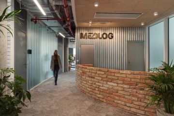 A woman walking past the reception desk