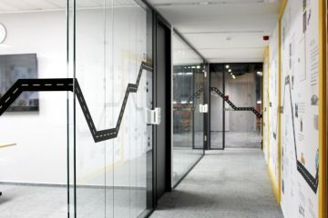 Glass corridor with graphics on the walls