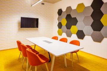 Meeting room in orange with acoustic panels.