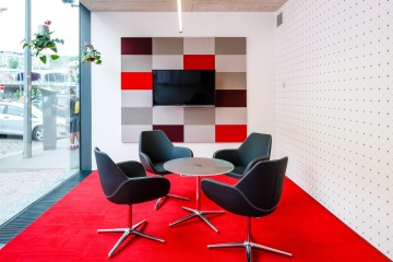 Meeting room in red-black color with acoustic panels in Seznam company.