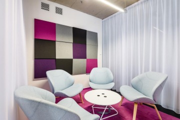 Meeting room in purple with soft seating interior.