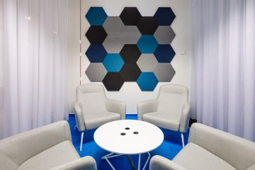 Dark blue meeting room with acoustic panels.
