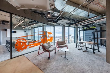 Glass-walled meeting room with an automotive theme