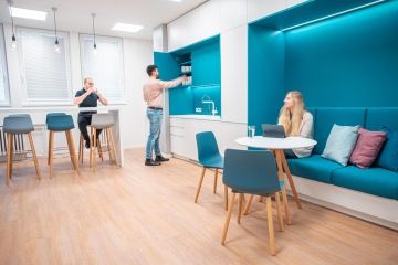 Cozy kitchen in blue with bar table and chairs
