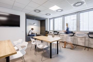 Workspace with high chairs by the window and a comfortable box for Toyota employees
