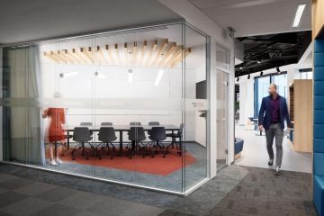 Glazed meeting room separated by glass partitions from the corridor in the company UniCredit Bank