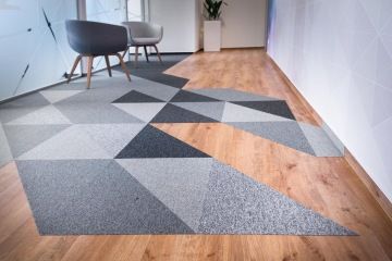 Kobercové dlaždice ve spojení s vinylem v přírodním provedení se sladěnými židlemi vytvářejí luxusní dojem.