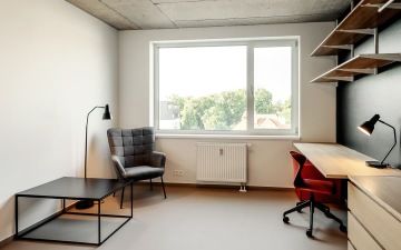 A lighted room with a work and chill zone