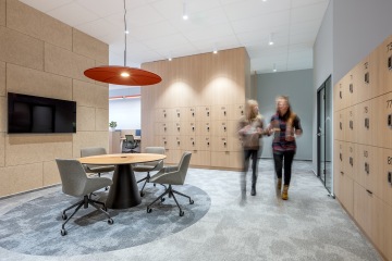 Unusual design of an office room with a glass door with a simple interior and natural light creating a pleasant atmosphere in the workplace.
