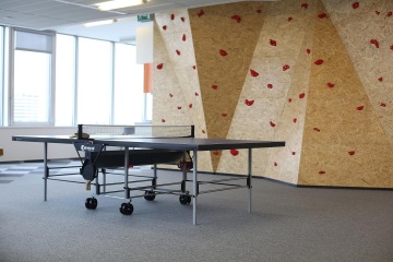 A climbing wall, ping-pong table and table football are installed in the relax zone.
