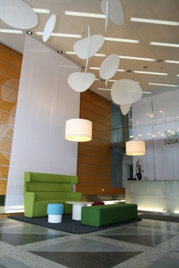 Green sofa with white table and round lamps at the Charles Squere Center on Charles Square.