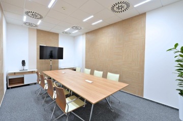 Pleasant to familiar client zone of Otidea a.s. creates a wooden table with a metal construction, design chairs and wallpaper on the walls.